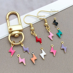 Macro view of colorful enamel lightning bolt pendants and gold stainless steel jewelry findings