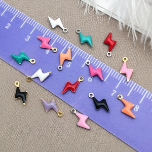 Colorful enamel lightning bolt pendants for DIY jewelry making on measurement scale