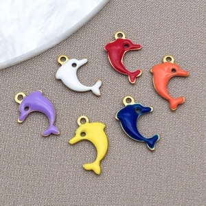 Detail of colorful enamel dolphin pendants for jewelry making in various vibrant shades