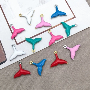 Macro shot of colorful enamel mermaid tail pendants for DIY jewelry crafting