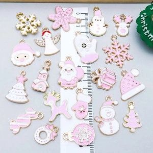 Pink and gold Christmas charms set with snowflakes and reindeer, displayed with ruler