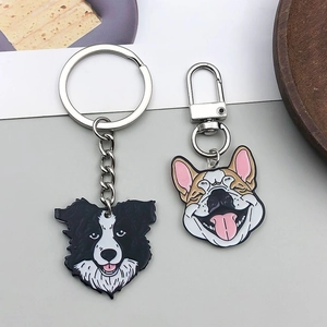 Close-up of enamel cartoon dog keychains with Border Collie and Corgi metal charms
