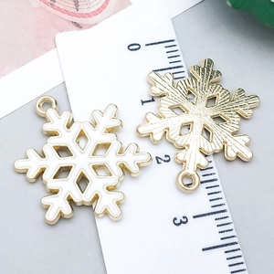Macro view showing dimensions of white snowflake enamel charms with gold alloy plating