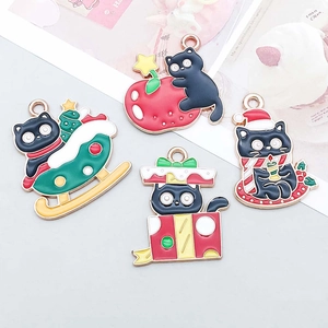 Detail of colorful Christmas black cat enamel charms for DIY jewelry making and crafts