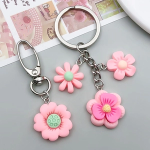 Detailed view of pink resin sunflower pendants with silver lobster clasps and rings