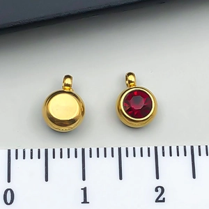 Detailed 8mm gold stainless steel round pendant charm with red crystal and ruler reference