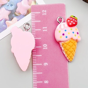 Close-up of resin ice cream cone charm with pink cream, strawberry and silver loop
