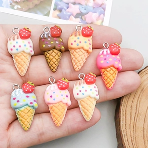 Colorful resin ice cream cone pendants for DIY jewelry making held in hand for scale