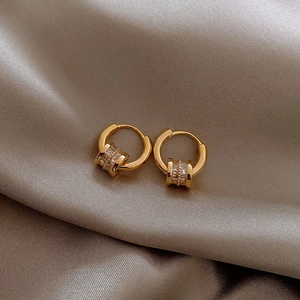 Elegant gold hoop earrings with sparkling cubic zirconia cylinder charms on silk