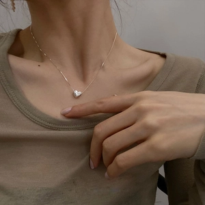 Elegante collar con colgante de corazón plateado para mujer con un estilo minimalista