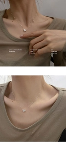 Détail du collier avec pendentif cœur en argent sur le cou montrant la chaîne et le fini poli