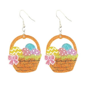 Close-up of Easter basket earrings with glitter eggs and pink bow decoration