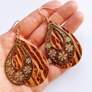 Retro hollow flower teardrop earrings with brown leather and golden metal accents