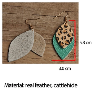 Detail view of Bohemian leaf earrings showing genuine leather and leopard print texture