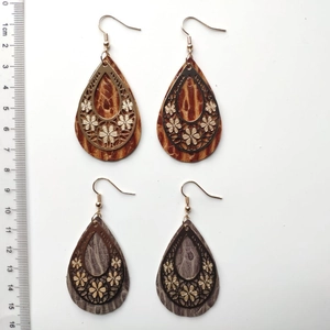Vintage leather teardrop earrings with golden floral filigree and scale measurement