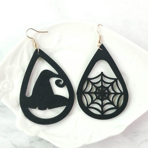 Close-up of black teardrop earrings featuring wizard hat and spider web silhouettes