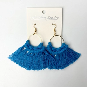 Detail of royal blue handmade woven fringe earrings with golden metal ring and hook