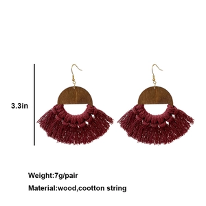 Bohemian wood and burgundy cotton tassel earrings measuring 3.3 inches in length