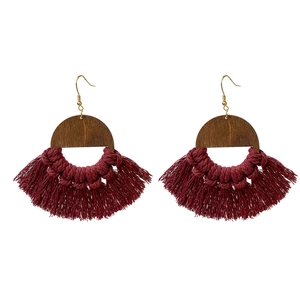 Bohemian fan-shaped wooden earrings with burgundy handmade cotton tassels on white background