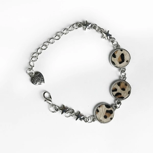 Detail of leopard print leather bracelet with star charms and heart-shaped pendant