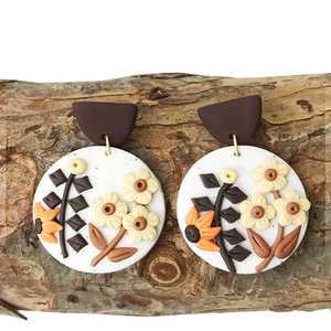 Handmade white polymer clay round earrings with textured yellow and orange flower petals
