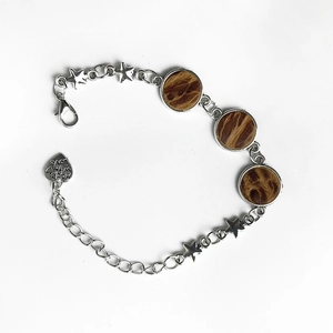 Detail of silver chain bracelet with star charms and 'made with love' heart pendant