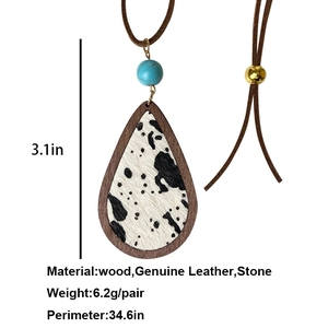 Bohemian teardrop necklace with cow print leather, wood frame and turquoise bead accent