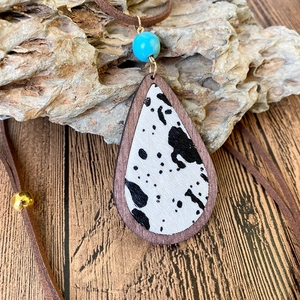 Bohemian cow print teardrop pendant necklace with turquoise bead and wood frame