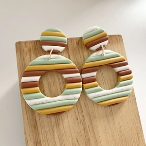 Handmade polymer clay rainbow striped earrings with geometric round drop design