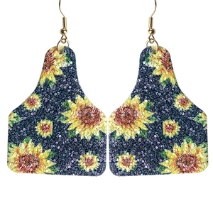 Boho-Ohrringe in Kuhmarken-Form mit Sonnenblumenmuster und goldenen Haken auf Weiß