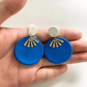 Artistic handmade clay earrings with white and blue geometric circular dangles
