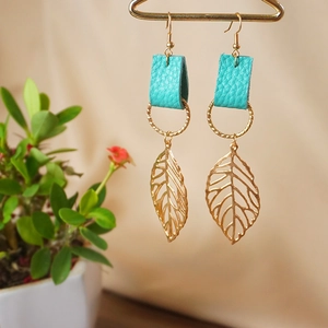 Creative leaf earrings in gold metal and green leather, dangling natural forest style