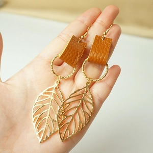 Creative leaf shaped drop earrings with metallic finish and textured brown leather