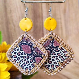 Close-up of bohemian square earrings with leopard print and yellow woven texture detail