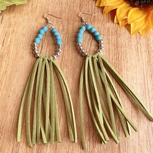 Detail of bohemian long olive green tassel earrings with turquoise beads and silver accents