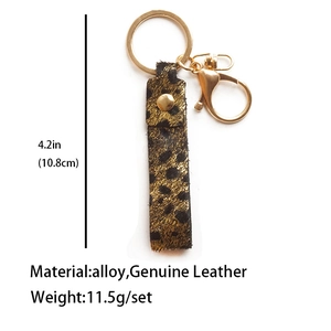 Detailed view of leopard print leather keychain with 10.8cm size and weight specs
