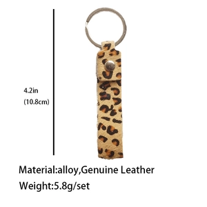 Detail view of leopard print genuine leather keychain with size and material specifications