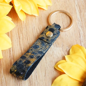 Luxury leopard print leather and pony hair keychain with sparkling gold dots and metallic ring