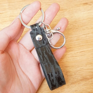 Handmade black leather keychain with embossed crocodile pattern and silver lobster clasp