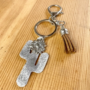Detail of bohemian cactus keychain with sunflower charm and dark brown leather tassel