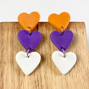 Handmade polymer clay heart earrings in orange, purple and white with metal links