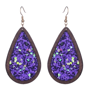 Handmade wooden teardrop earrings with purple glitter inlay and gold hooks for Halloween