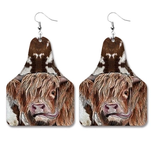 Faux leather earrings featuring highland cow print in a western cattle tag shape