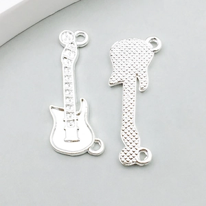 Detail of silver electric guitar pendants with textured back and dual loops for jewelry