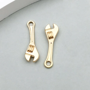 Nahaufnahme goldener Rollgabelschlüssel-Anhänger für DIY-Schmuck und Schlüsselanhänger