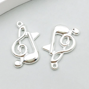 Detail of silver musical note pendant with treble clef design for DIY jewelry making