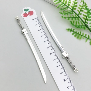 Detail of silver alloy katana pendants with ruler showing 10.5cm length for DIY jewelry