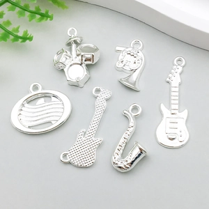 Detailed collection of silver music instrument charms including guitar, drum, and saxophone