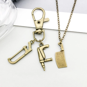 Macro detail of bronze alloy saw and chainsaw tool charms for DIY jewelry making