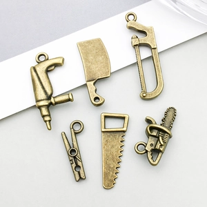 Detailed view of bronze-toned mini tool alloy charms for DIY jewelry making and crafts